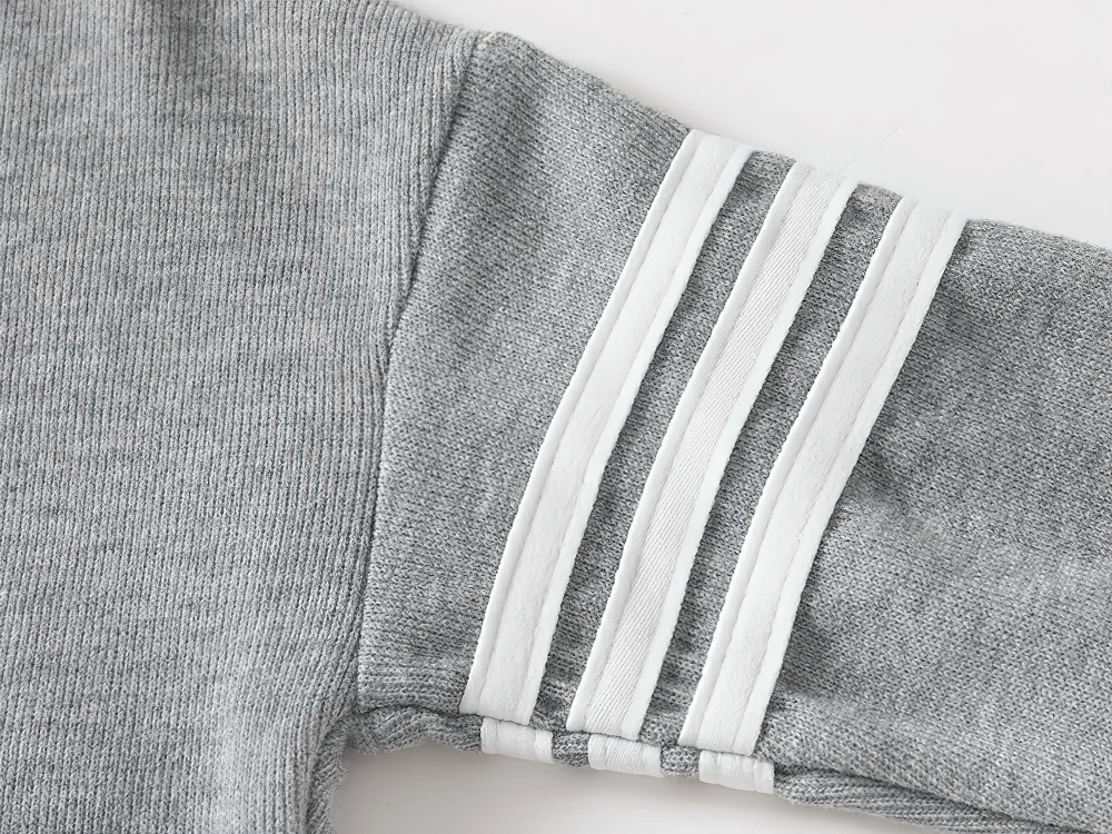 Gray kid's hooded sweatshirt sleeve with white stripes, fleece-lined for comfort.